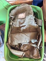 Olive canvas backpack inside green tote
