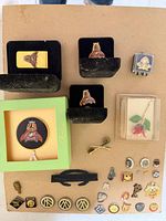 Overview of all pins, tie bars, money clip, cufflinks on board