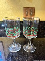Front view of both holly pattern wine glasses
