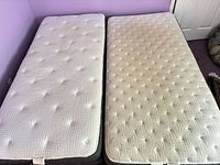 Both twin mattresses side by side on foundations