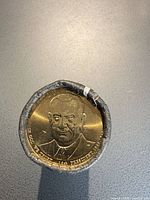 End view of sealed roll showing uncirculated Lyndon B. Johnson Presidential $1 coin