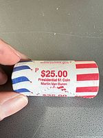 Close-up of sealed roll showing denomination, president name, mint mark and wrapper design