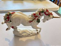 Left side view of unicorn figurine showing decorations