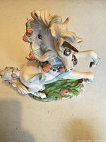 Top view of porcelain unicorn figurine showing mane, flowers and base