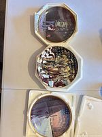 All three plates in Styrofoam packaging, fronts visible