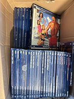 Stack of sealed blue-spined Time-Life Rock ’N’ Roll Era LP albums visible inside box, including title “1962”.