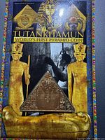 Front of packaged pyramid-shaped coin with Tutankhamun artwork