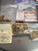 Overall lot showing bags of loose cents, wrapped rolls and single coin