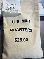 Front view of canvas coin bag with text and Wyoming tag
