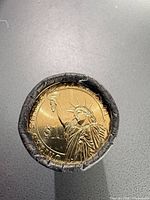 End view of roll showing Statue of Liberty reverse of Woodrow Wilson dollar