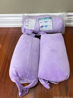 Two unwrapped pillows beside vacuum-sealed roll containing additional pillows