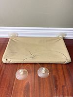 Full view of beige canvas cat window perch with four suction cups and support cables