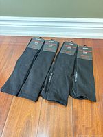 Four pairs black socks with hang tags