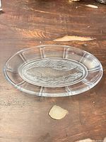 Top view of oval clear glass platter showing fish motif and rim segments