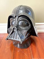Front view of black Darth Vader helmet mask on stand