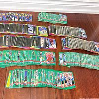 Wide view of multiple stacks of Donruss baseball cards laid out on hardwood floor