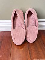 Front view of both slippers upright showing quilted upper and toe