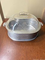 Complete roaster with lid on showing hammered aluminum body and etched lid design