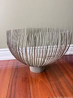 Front angled view of wire bowl showing overall form and finish