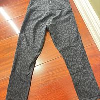 Front view of Lululemon black/gray camo capri leggings laid flat