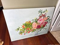 Front view of entire floral painting leaning against wall