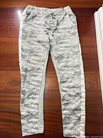 Full front view of grey camo joggers with silver side stripe