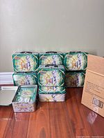 Stack of nine Arceus Pokémon collector tins next to opened tin showing metal construction