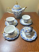 Entire tea set displayed: teapot, 4 teacups, 4 saucers