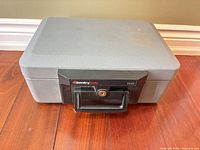 Front view of gray SentrySafe 1110 portable safe