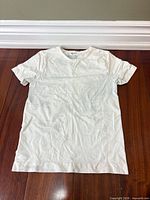 Full view of off-white tie-dye Skims top laid flat