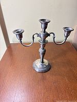 Front view of Birks sterling silver three-arm candelabra