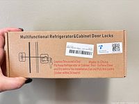 sealed brown box labelled Multifunctional Refrigerator & Cabinet Door Locks