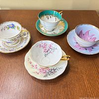 All four teacup and saucer sets displayed