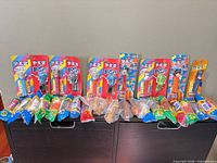 Group shot of all carded PEZ dispensers with candy refills displayed in front