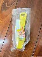 Front view of sealed yellow Crackle watch with instruction sheet visible