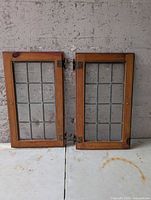 Front view showing both cabinet doors natural pine side with leaded glass