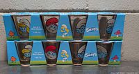 Front view of two boxed sets showing Smurfs graphics on glasses