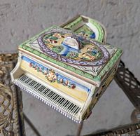Overall view of ceramic grand piano cigarette box showing keyboard front and painted lid