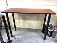 Full view of one high-top table showing top and legs