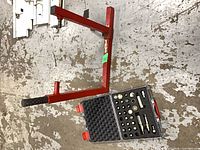 Overall view of red Abba stand and closed adapter kit case