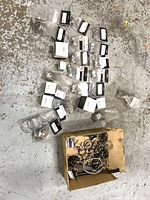 Overall lot showing sealed Helix packs, boxed clamps and loose clamps