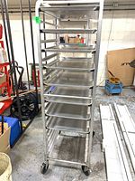 Front angle of aluminum baker's rack with multiple pan slides and casters