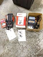 All three devices with boxes and manuals