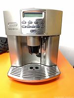 Front view showing control panel, coffee spouts, drip tray