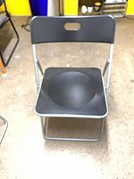 Front view of a black folding chair showing seat and backrest