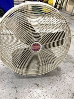 Front view of 27" metal cage fan with three blades and central LFI badge