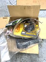 Box with multiple packaged motorcycle parts visible