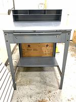 Front view showing drawer, lower shelf, and upper organizer shelves