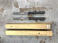 Pair of fork assemblies with original boxes
