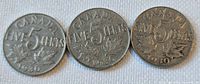 Reverse view of three 1930 Canadian 5-cent coins showing denomination, maple leaves, and date.